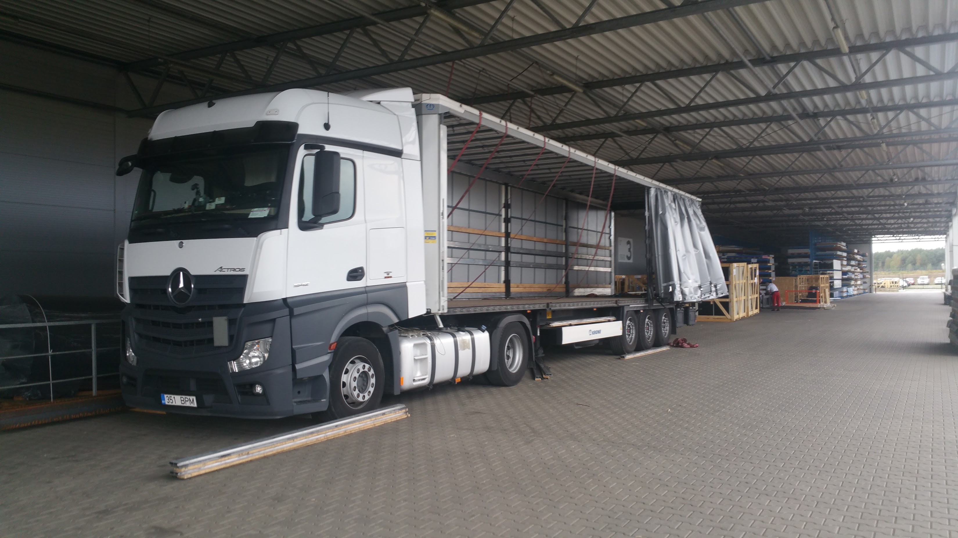 Speedtrans truck with an open curtainsider trailer at a warehouse
